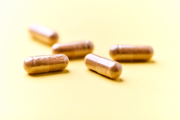 Carnitine capsules. Concept for a healthy dietary supplementation. Bright paper background. Soft focus. Close up.	