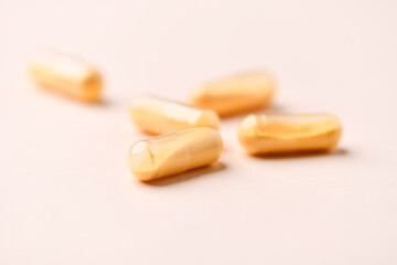 Coenzyme Q10 capsules. Antioxidants. Concept for a healthy dietary supplementation. Bright paper background. Soft focus. Close up. Copy space.	