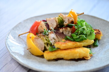 Grilled Chicken Skewer with Vegetables, Polenta and Fresh Greens