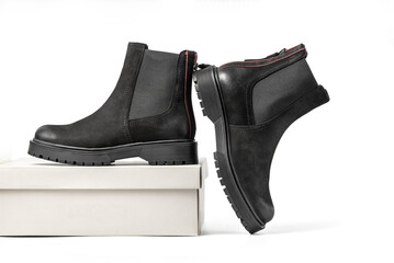 Female casual flat leather ankle boots on its box. Isolated on a white background with clipping path included