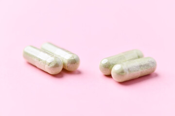 Barley grass capsules. Antioxidants. Concept for a healthy dietary supplementation. Bright background. Soft focus. Close up. Copy space.