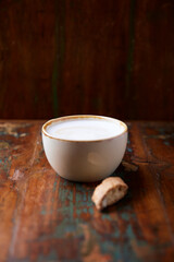 Cappuccino on dark wooden background. Soft focus. Close up.	