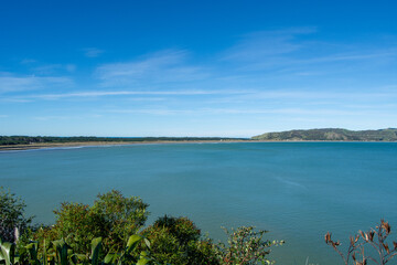 Serene Coastal Landscape Under Clear Blue Sky