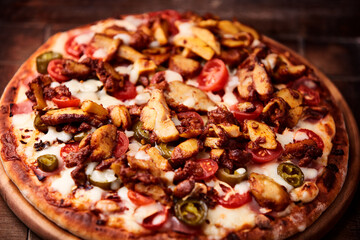 Gyros Pizza with jalapeno pepper, cherry tomatoes and mozzarella cheese. Soft focus. Close up.	