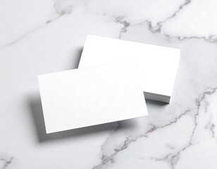 Blank white business card mockup on a luxury marble background. A clean template for corporate identity and professional branding.