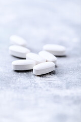 Amino acids tablets on wooden background. Soft focus. Close up	