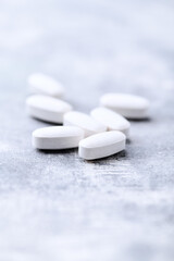 Amino acids tablets on wooden background. Soft focus. Close up	