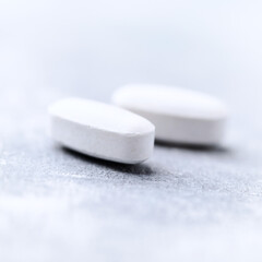 Amino acids tablets on wooden background. Soft focus. Close up	