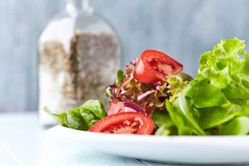 Healthy and tasty salad with tomatoes, olives, cucumber, and lettuce.