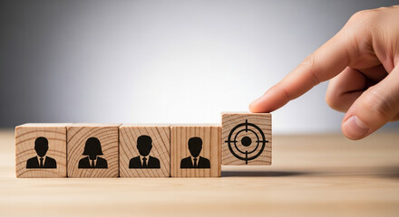 Finger pushing wooden block with target symbol towards row of people icons