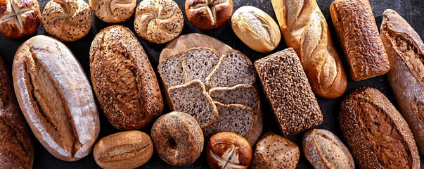 Assorted bakery products including loaves of bread and rolls