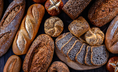 Assorted bakery products including loaves of bread and rolls