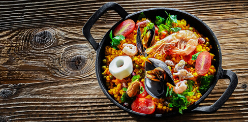 Seafood paella served in a cast iron pan