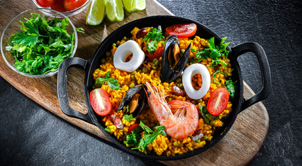 Seafood paella served in a cast iron pan