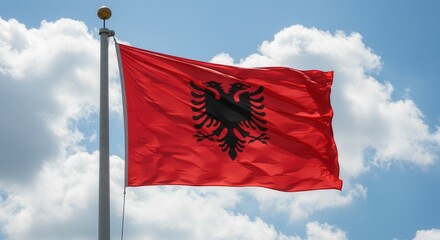 Naklejka premium Albania National Flag Waving on Tall Flagpole in Sky with Clouds – Albania Independence Day Celebration, Patriotism, Freedom, Albanian Culture & Heritage