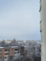 Snow-covered view of city buildings