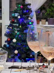 Glasses of champagne on the background of a decorated Christmas tree