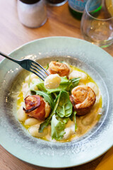 Gnocchi with creamy sauce and bacon-wrapped chicken