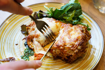 Cutting into crispy chicken parmigiana