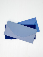Blue and light blue envelopes lie on white background, message concept