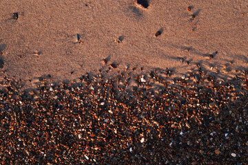 Transition between sand and tiny pebbles - natural textures side by side