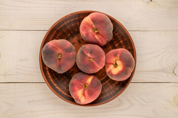 Sweet fig peaches on a wooden table, top view, macro.