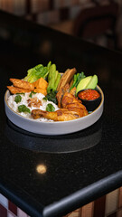 White Rice with Fried Chicken, Tempeh, Tofu, and Chili Sauce on Black Table