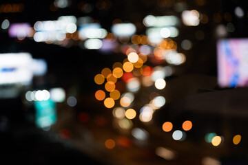 Night shows reflection from cars tail lights and street lighting on road. Abstract background for...