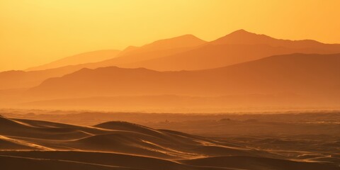 The breathtaking sunset illuminating the serene desert and distant mountains.