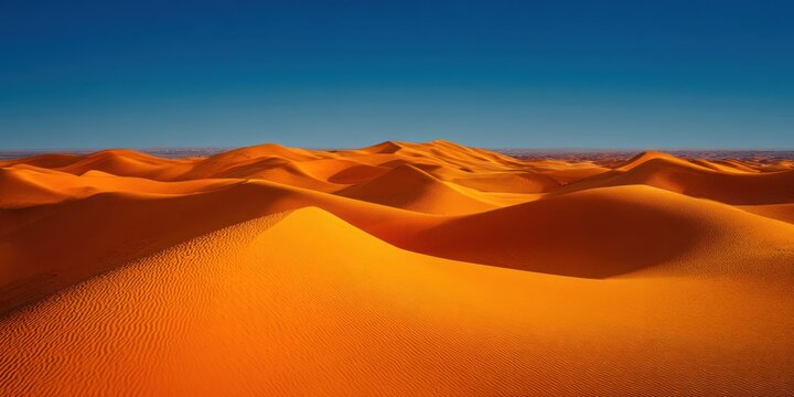 The majestic desert landscape showcasing endless golden sand dunes under a clear blue sky