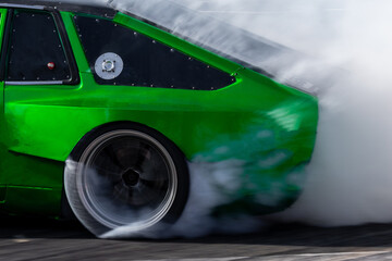 Car drifting, Blurred image diffusion race drift car with lots of smoke from burning tires on speed track, Car drifting on speed track, Professional driver drive drifting car. © Kalyakan