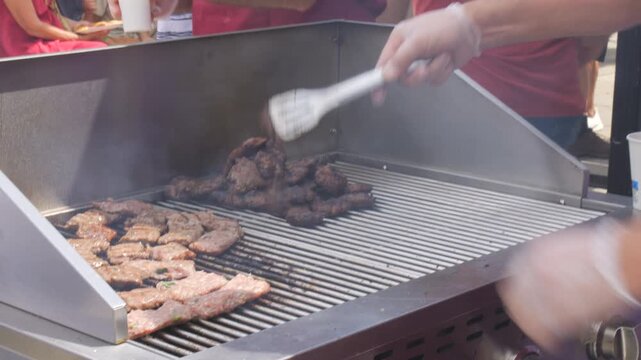Grilling Balkan-style cevapi and meat skewers at the festival