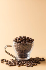 Glass coffee cup filled with roasted coffee beans, an allegory of rest
