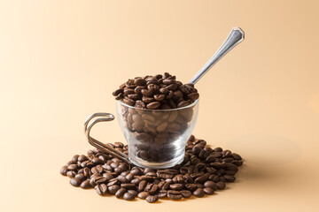coffee cup filled with coffee beans on an orange background