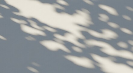 Abstract shadows of leaves creating a dreamy pattern on a gray wall