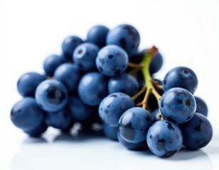 Fototapeta premium Fresh blue grapes arranged on a clean white surface, great for food and lifestyle photography