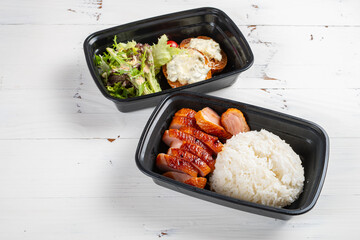 angle view takeout food of smoked duck breast rice served with salad and bread at horizontal composition
