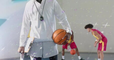 Camera panning upward showing coach timing players dribbling with animated stats guiding training - Powered by Adobe