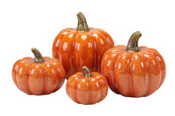 Four glossy orange ceramic pumpkins with speckled white glaze isolated on a transparent background image