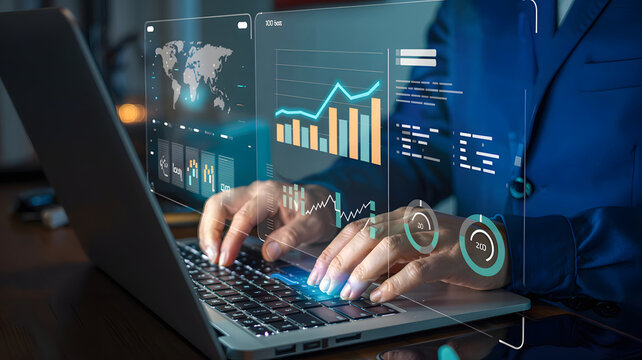 Professional analyzing global financial data on futuristic holographic interface while typing on laptop