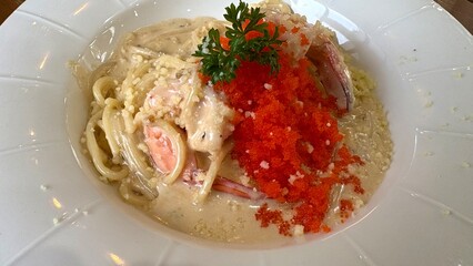 Close up Spaghetti with shrimp roe sauce in the white plate.