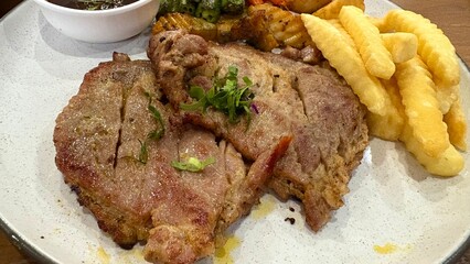 Close up pork steak with french fried in the restaurant.