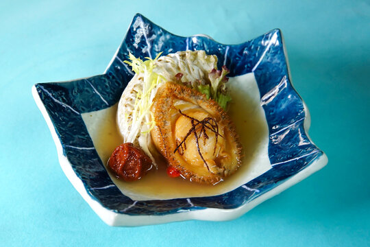 Gourmet Abalone with Preserved Plums and Salad served in plate side view of Chinese cuisine