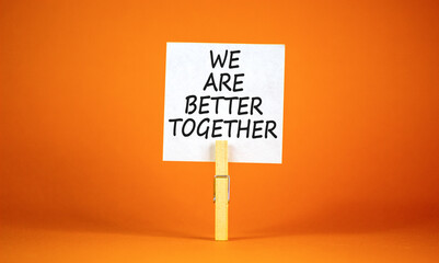 We are better together symbol. Concept words phrase We are better together on beautiful white paper on clothespin. Beautiful orange background. Business We are better together concept. Copy space.