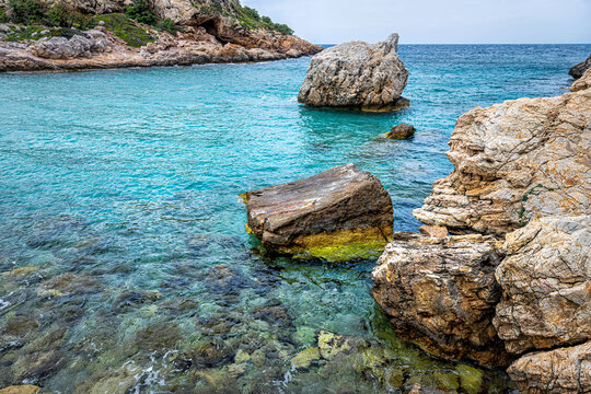 Iero beach cove birthplace of Greek god Dionysos or Dyonysus temple on Ikaria island Greece by Ikarian sea cliff rocks - Powered by Adobe