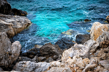 Iero beach cove blue water at Greek god Dionysos or Dyonysus temple on Ikaria island Greece by Ikarian sea cliff rocks