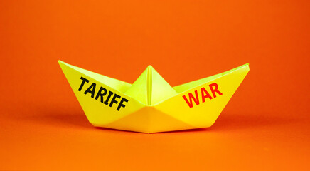 Trade tariff war symbol. Concept word Tariff war on beautiful yellow paper boat. Beautiful orange...