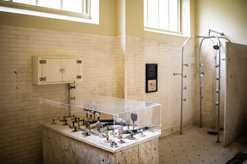 Hot Springs, Arkansas resort town city with historic natural mineral water spa bath house on bathhouse row with interior of national park building with sanatorium equipment with pipes shower