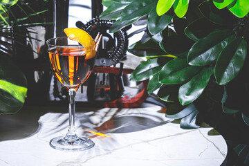 La Perla alcoholic cocktail drink amidst vibrant greenery at modern bar lounge setting