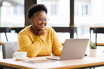 Happy African American Businesswoman Using Laptop At Workplace  Modern Office. Copy Space
